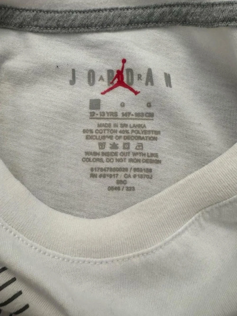 White Jordan kids t-shirt with red Air Jordan logo and 'Flight' text, size L